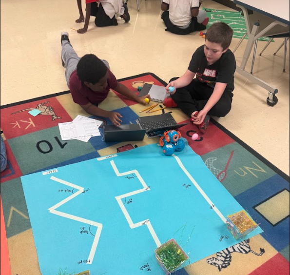students coding robot to navigate down a path