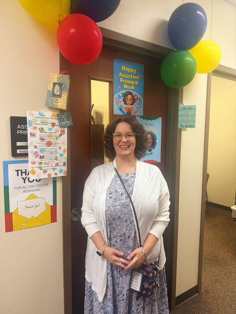 Lora King in front of her door display for Assistant Principal Week