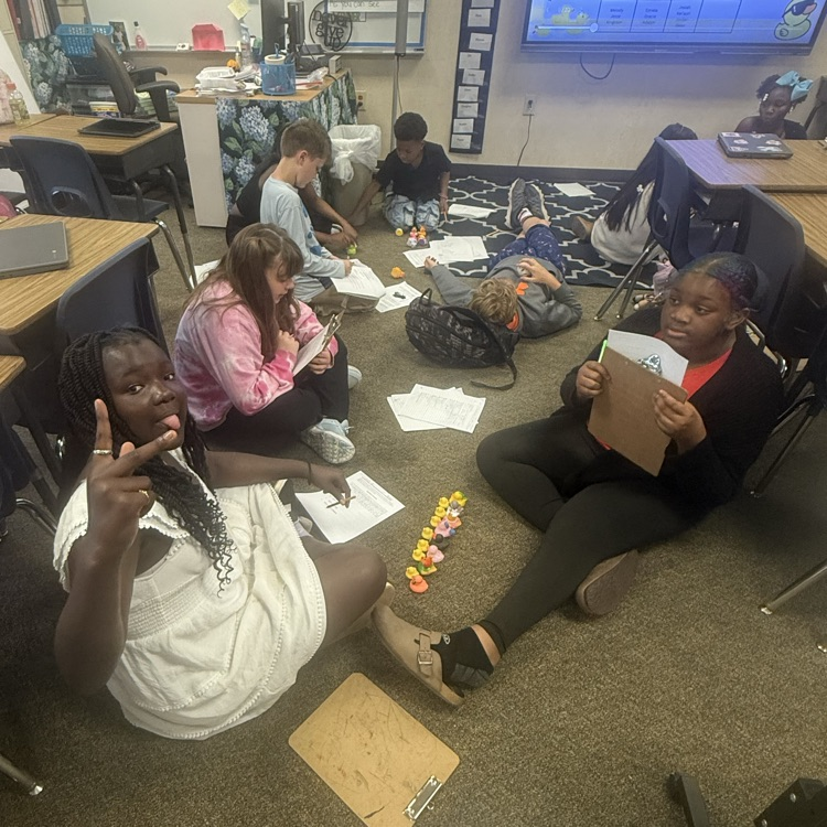 students working collaboratively in groups to earn rubber ducks