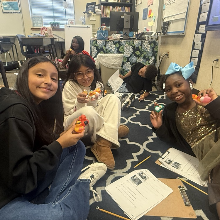 Students working collaboratively in groups to earn rubber ducks