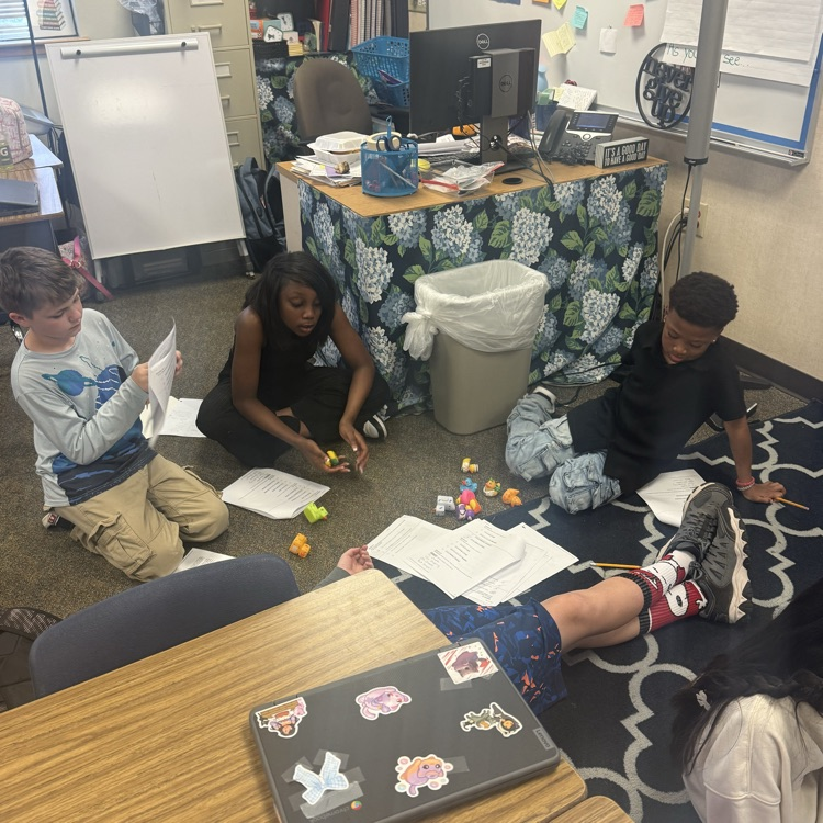 Students working collaboratively in groups to earn rubber ducks