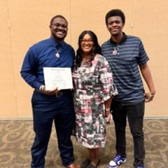 people posing with certificates