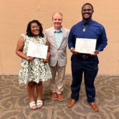 people posing with certificates