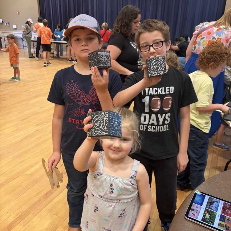 Students holding merge cubes