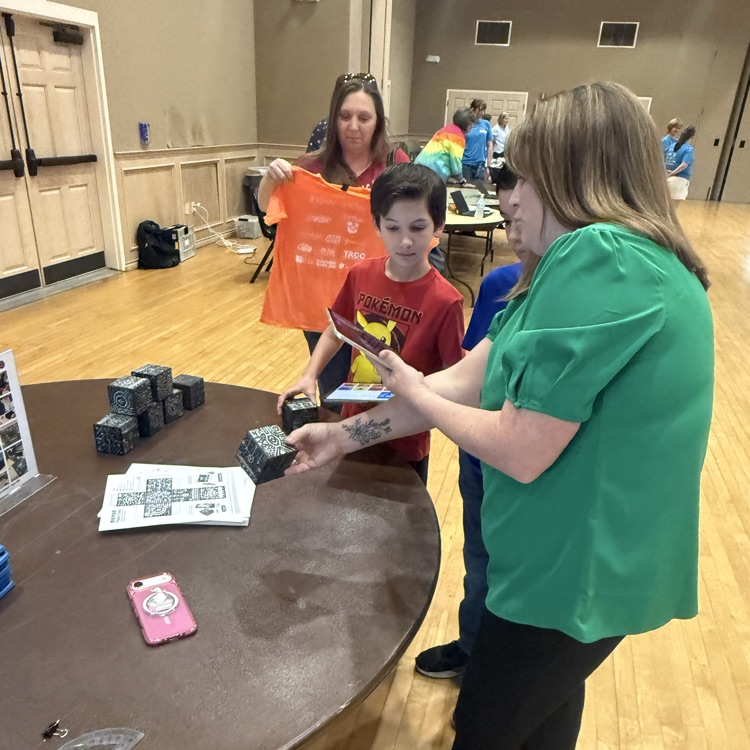 Teacher showing student and parent and iPad program