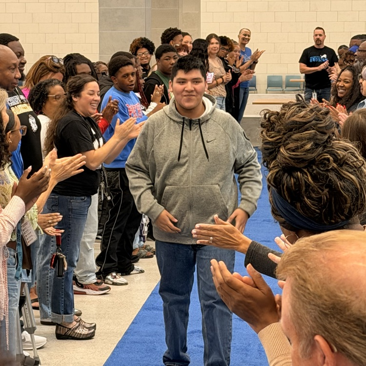 students walking blue carpet