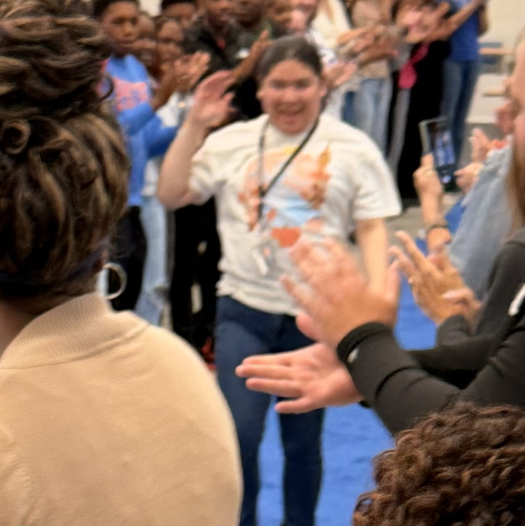 student walking blue carpet