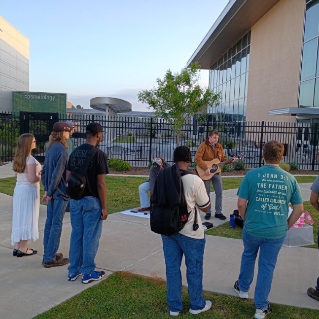 ECHS students gathering to worship and pray for the school and students.