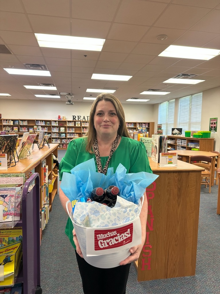 Birdwell Librarian smiles while holding her appreciation basket.