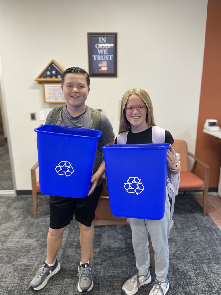 Hubbard students hold recycling trash cans for classrooms.
