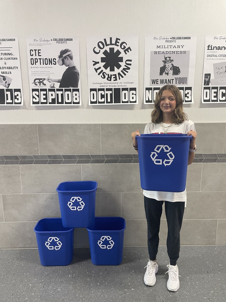 Hubbard student holds recycling trash cans for classrooms.