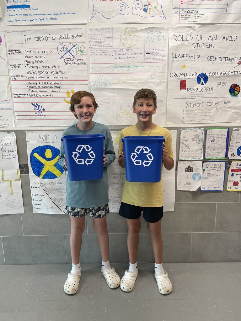 Hubbard students hold recycling trash cans for classrooms.
