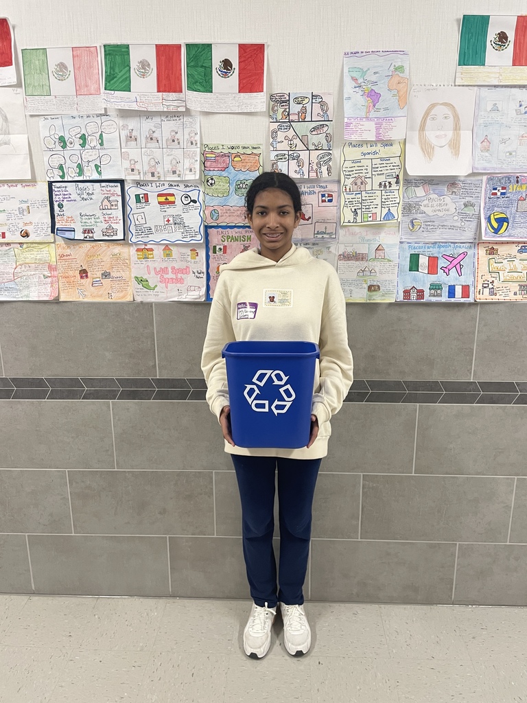 Hubbard student holds recycling trash cans for classrooms.