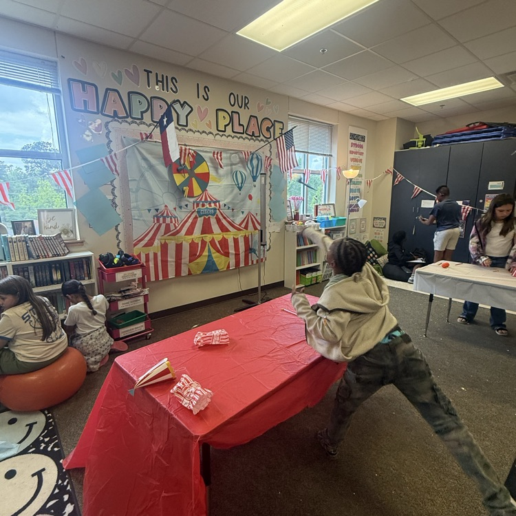 students playing carnival target throwing game 