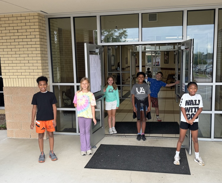 Friday friends greeting students coming into school