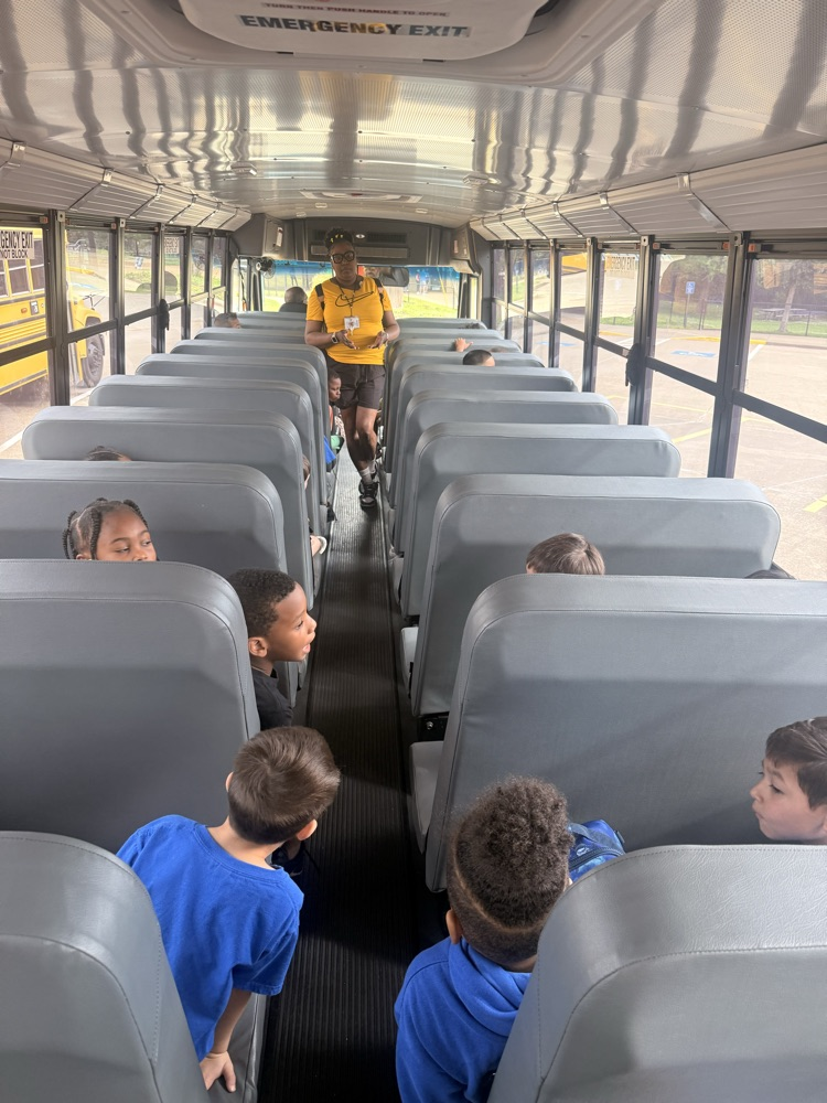 students listening to teacher on the bus