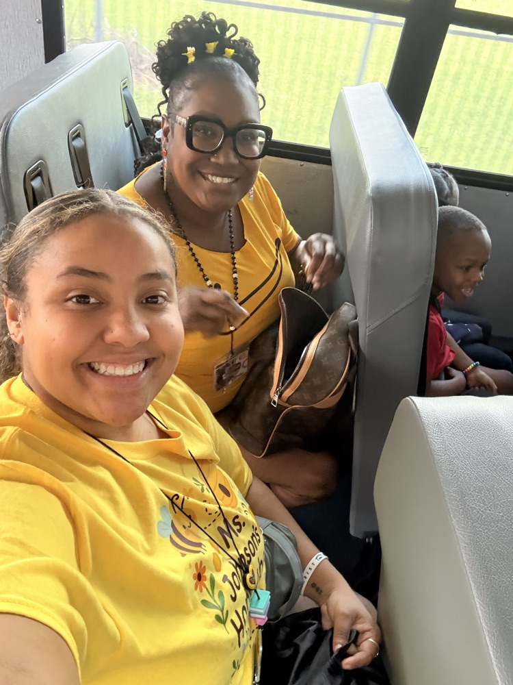 teachers smiling on the bus 