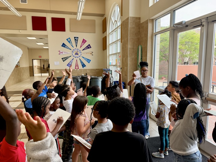 students listening to teacher and writing on whiteboards