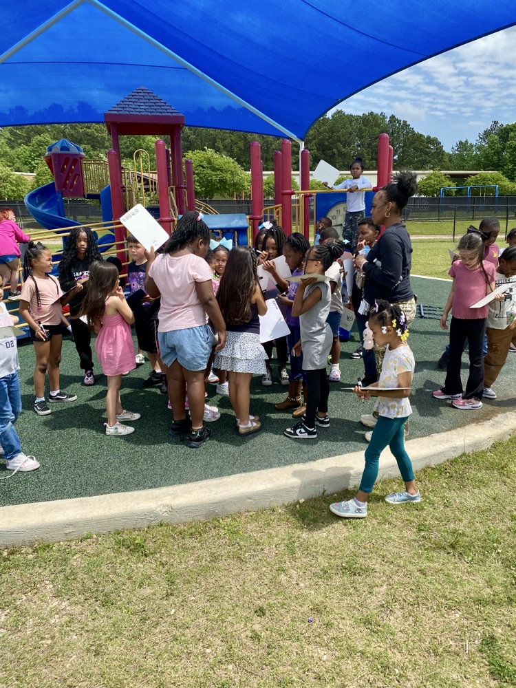 students listening to student read a clue
