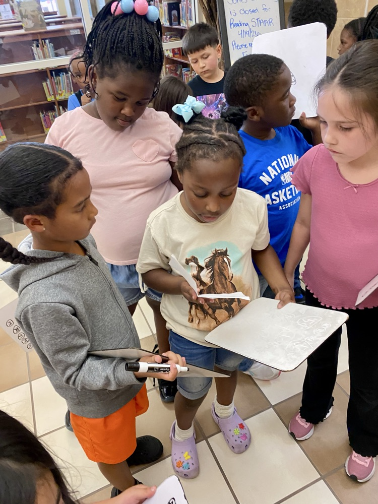 students listening to student read a clue