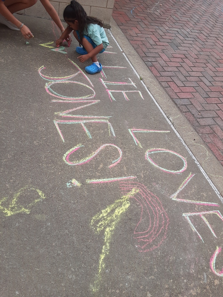 Child drawing with chalk on the ground