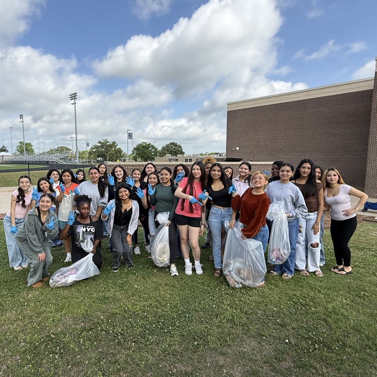 girls picking up trash