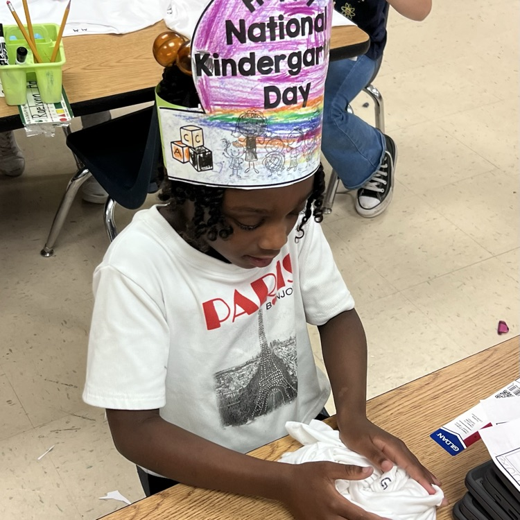 student lying up a shirt to dye 