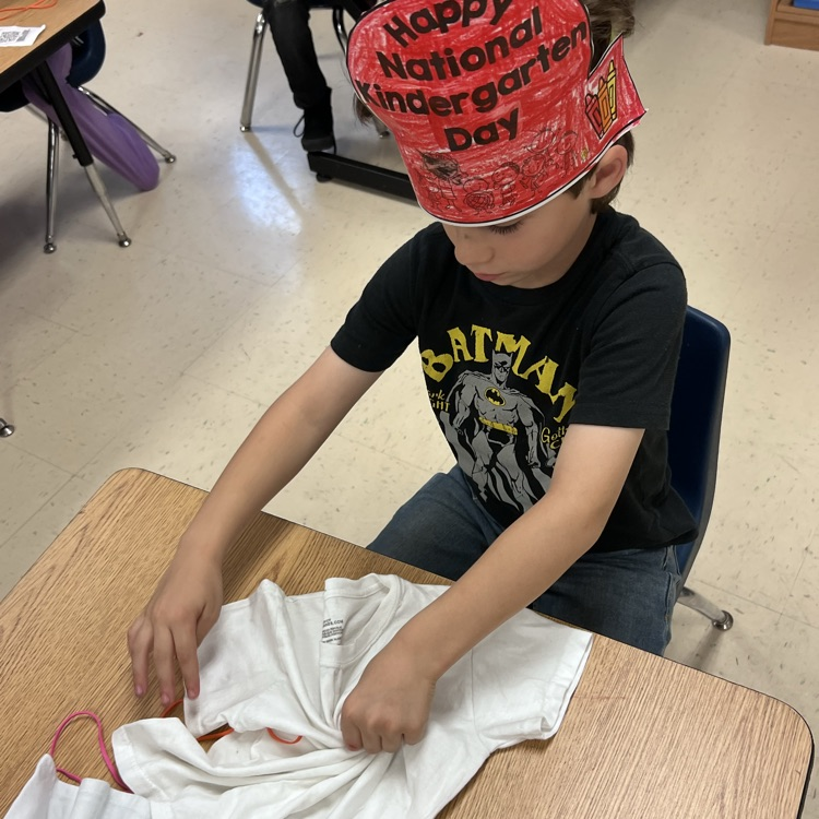 student lying up a shirt to dye 