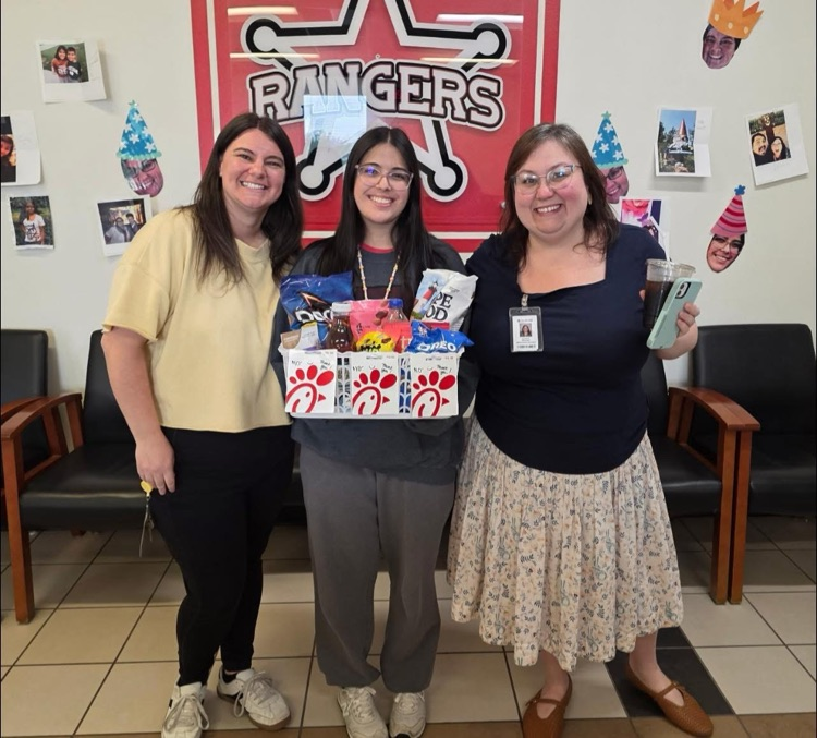 Front office staff holding a gift basket from PTA