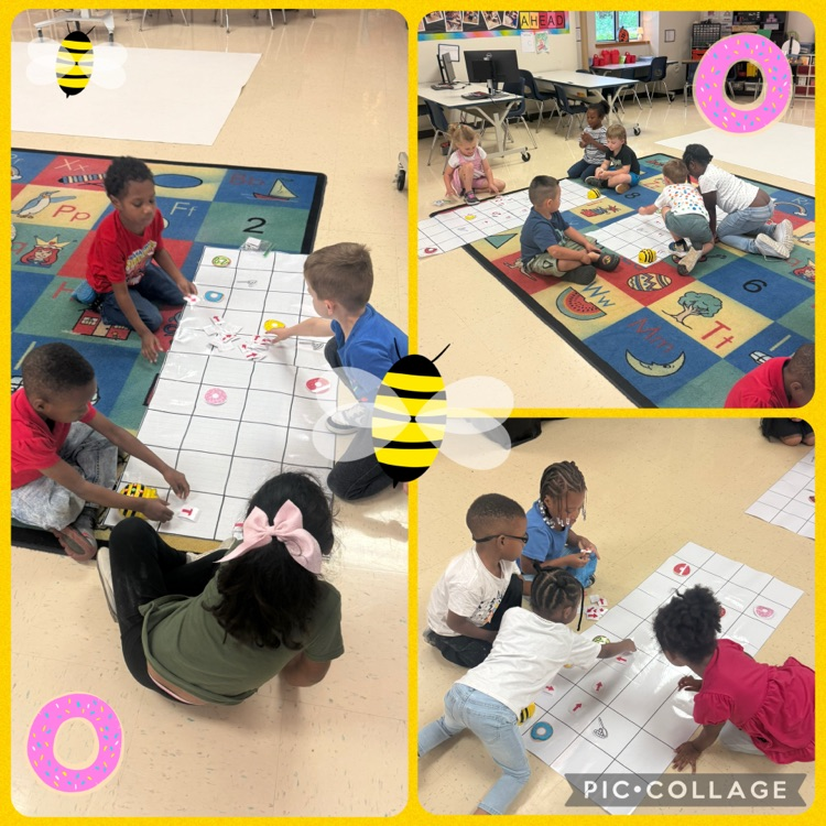 students working in teams to code a B robot