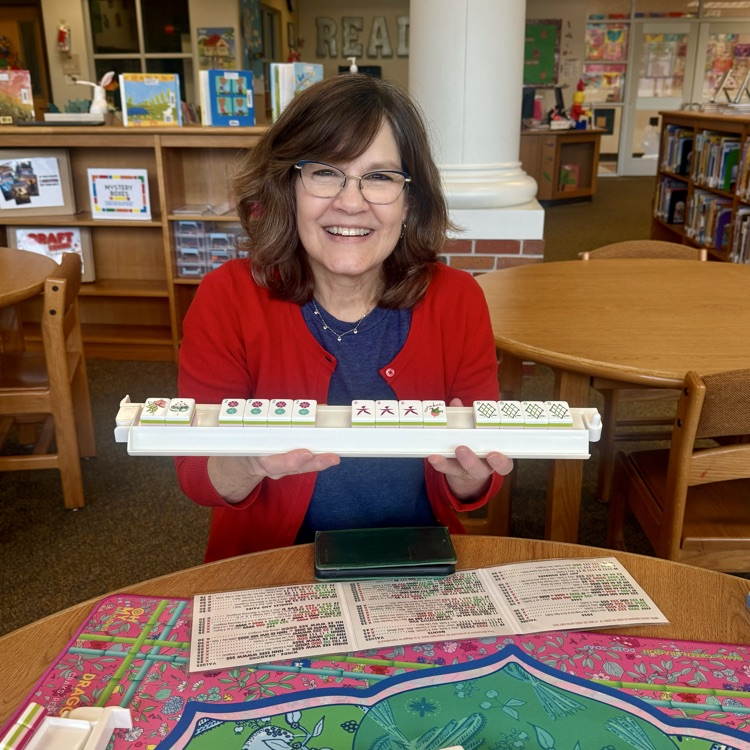 Teacher holding up winning mah-jongg