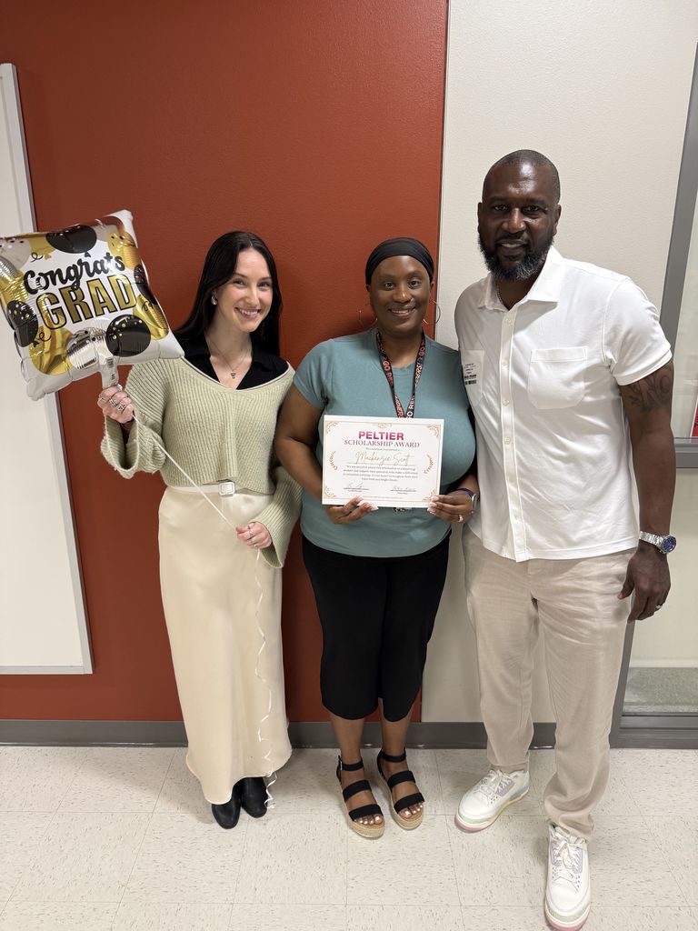 Mrs. Vickers with Peltier and the awarded scholarship