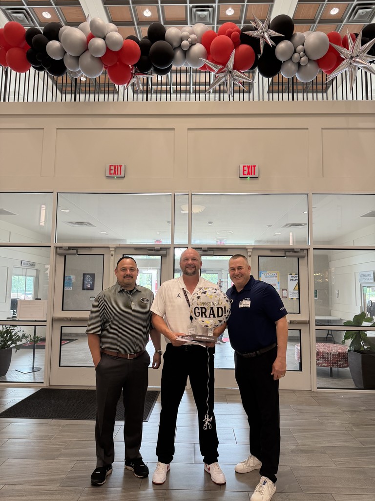 AP Coach Kniffen with Peltier and the awarded scholarship