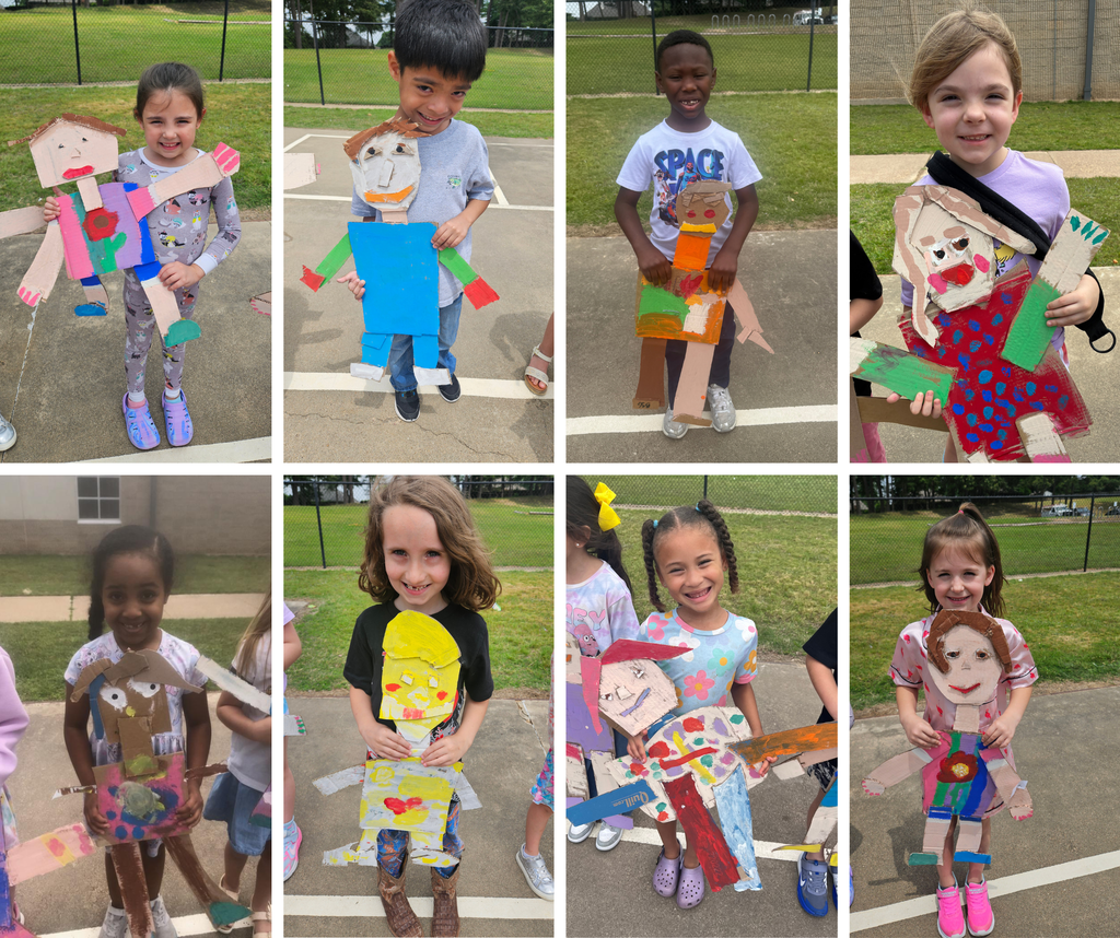 Kindergarten students holding their carboard "mini me's."