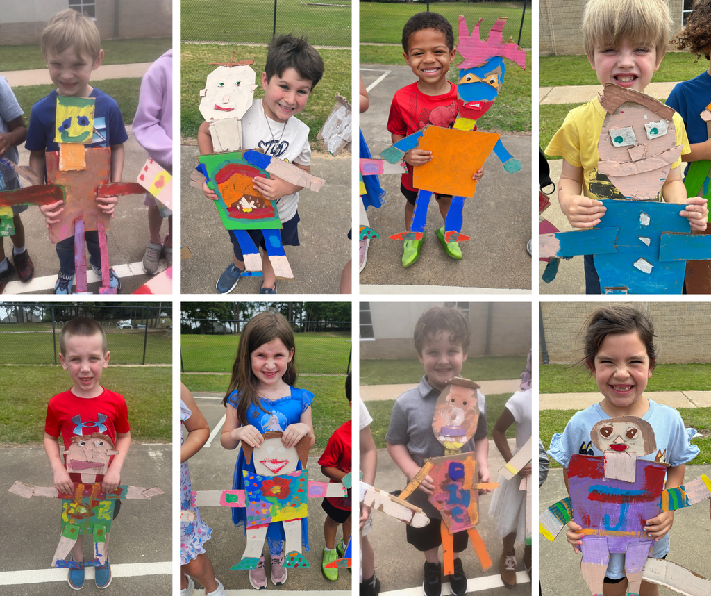 Kindergarten students holding their carboard "mini me's."