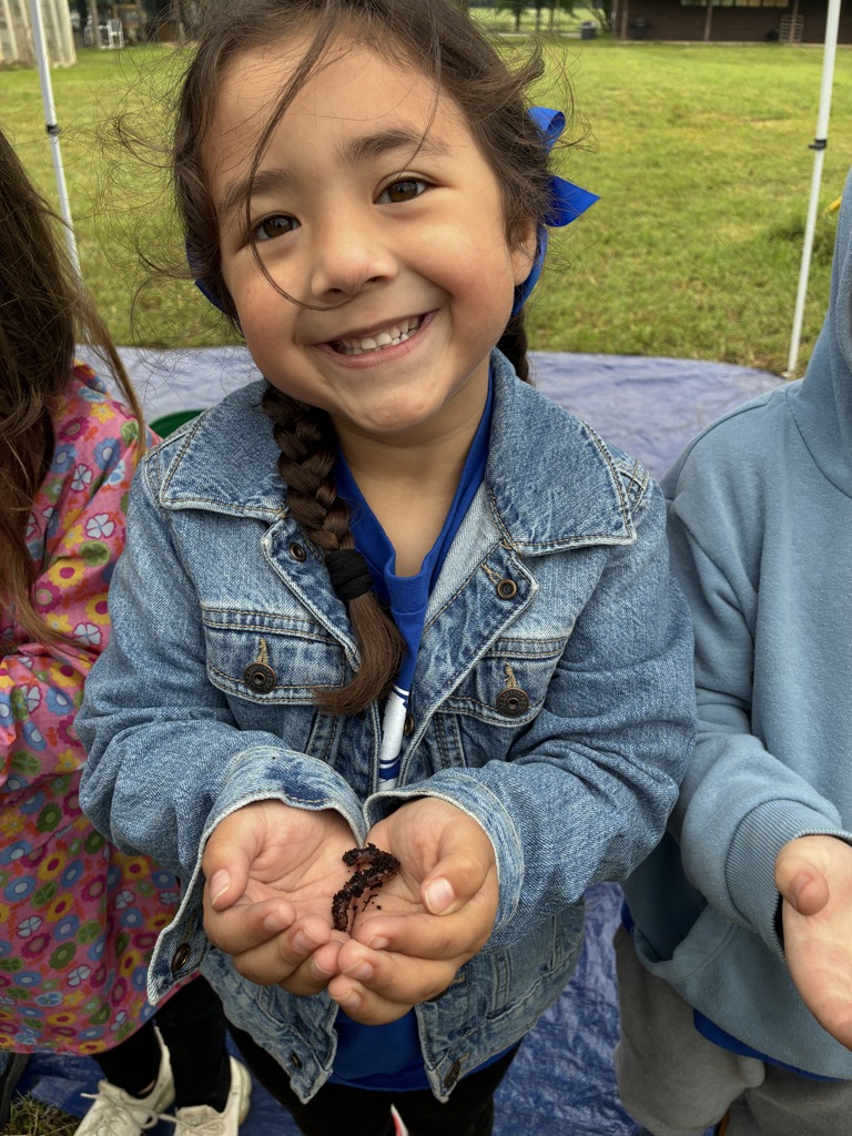 A student holding an earth worm.