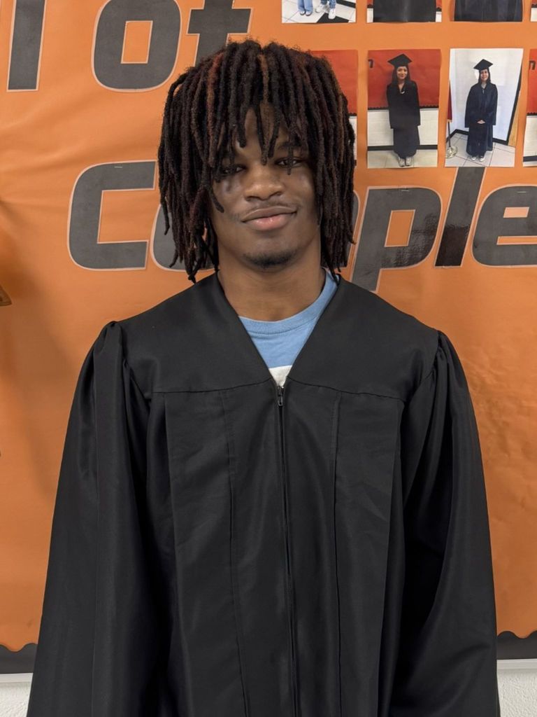 Student posing in graduation regalia