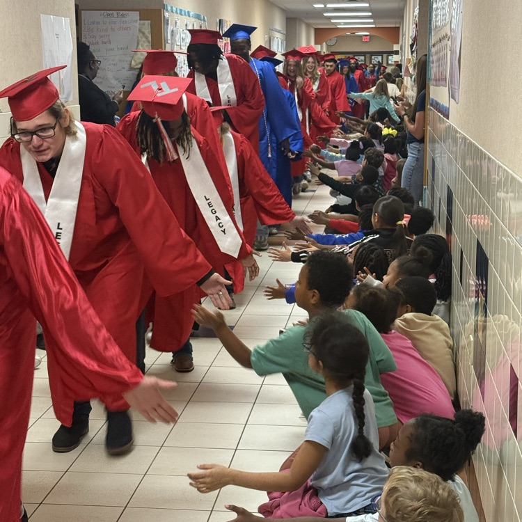 graduating seniors in their cap and gown walking hallways 