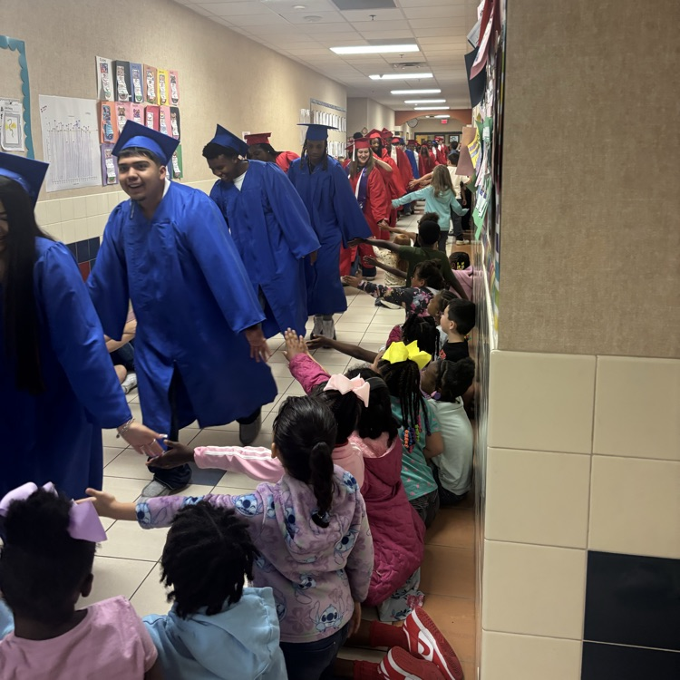 graduating seniors in their cap and gown walking hallways 
