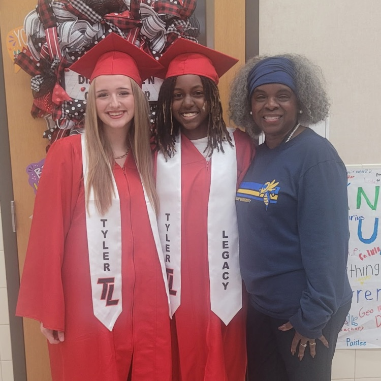 graduating seniors in their cap and gown walking hallways 
