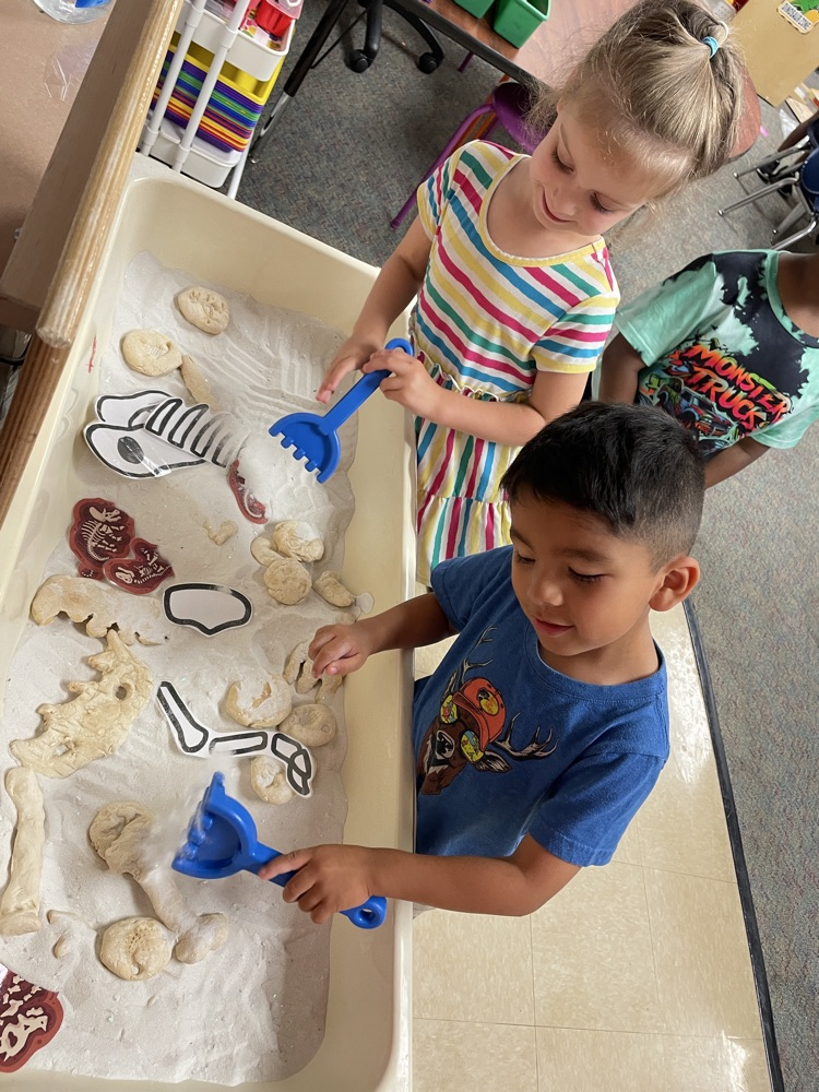 Kids doing dinosaur activities. 