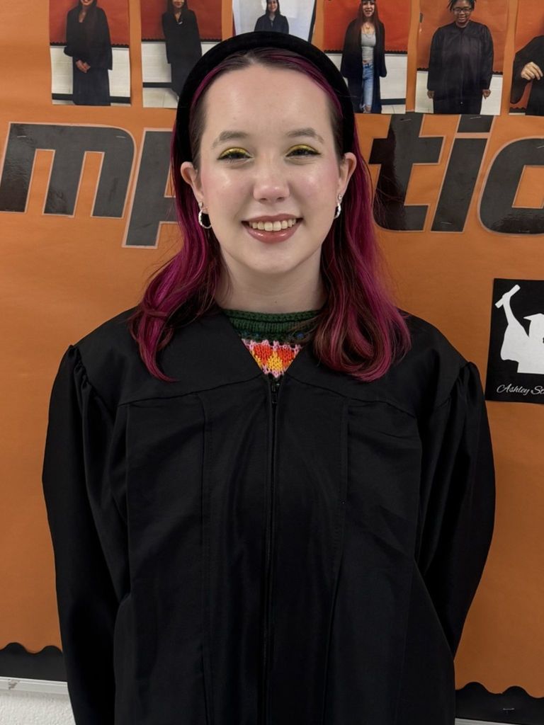 Student posing in graduation regalia