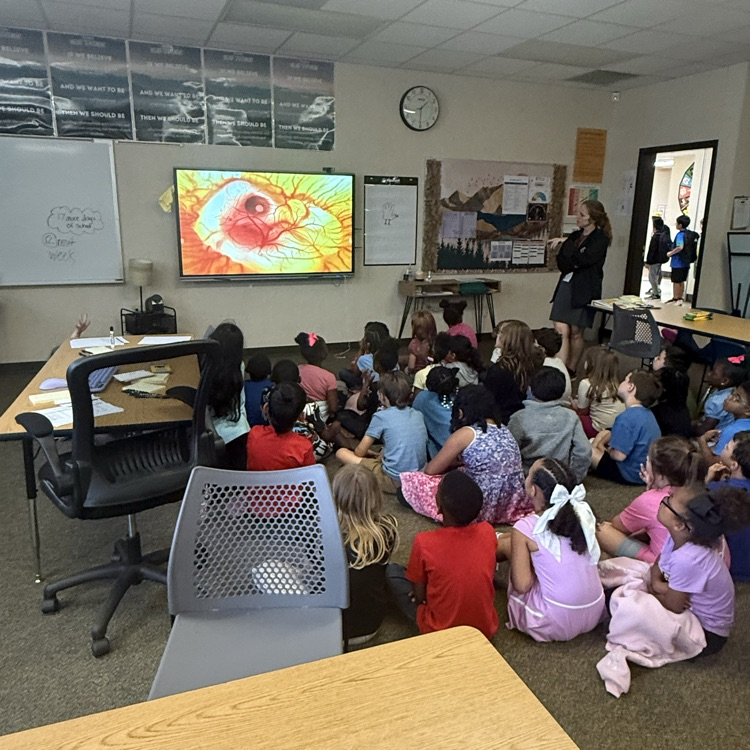 Mrs. Cureton principal teaching students about chicken life cycle 
