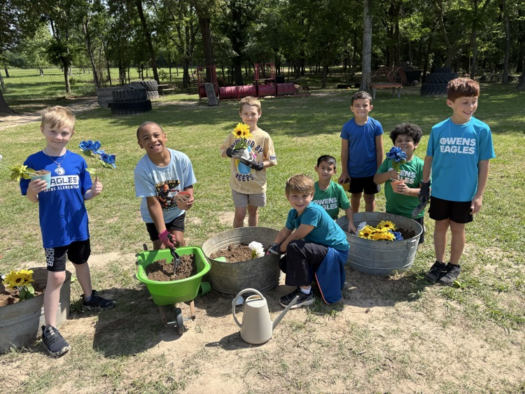 Kids on a field trip learning about plants and exploring in the soil
