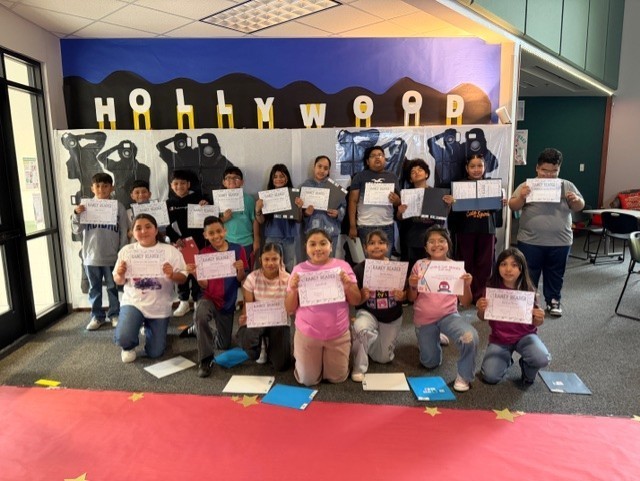 Students smiling and holding certificates