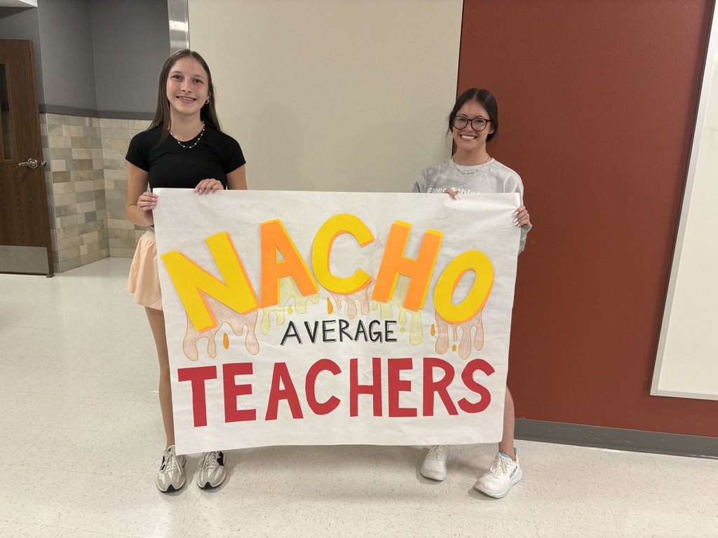 Student council members holding a sign that says "Nacho Average Teachers"