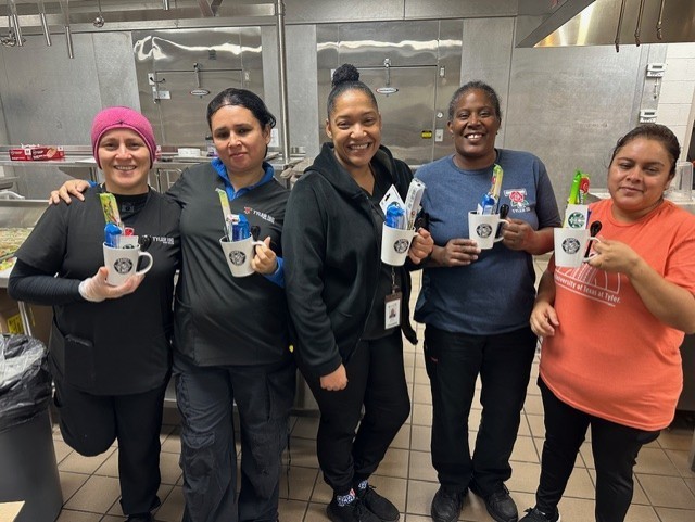 Five ladies holding coffee mugs