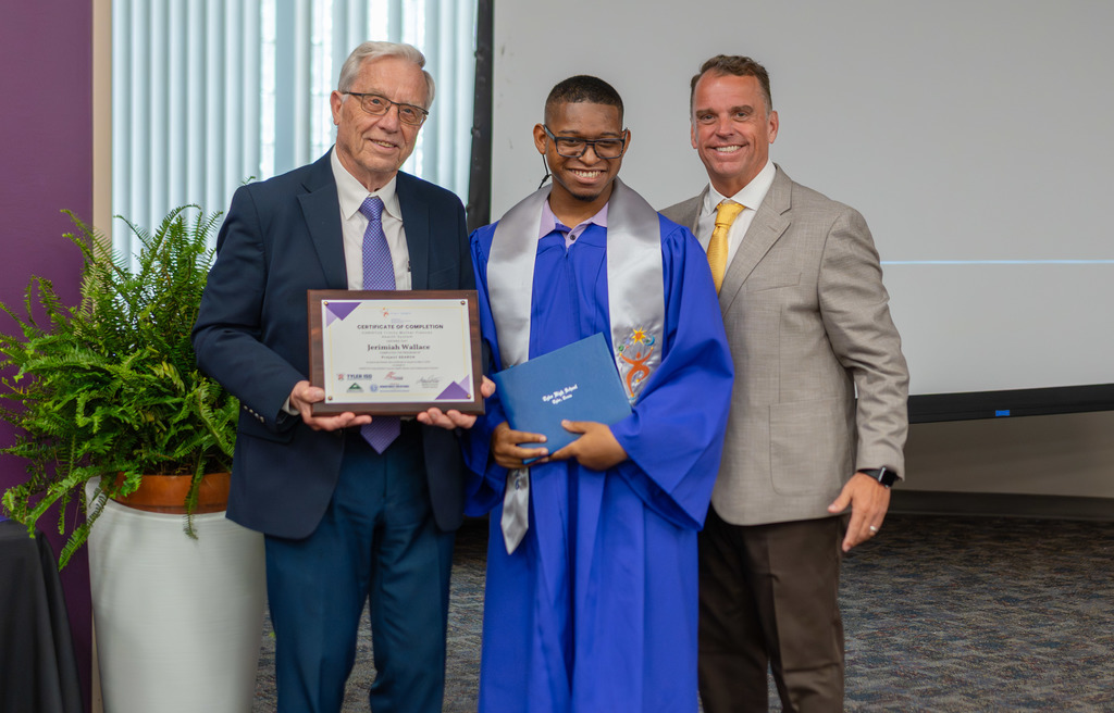 Project SEARCH Graduate and two men smile with diploma.