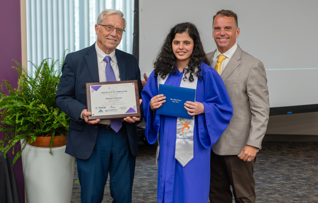 Project SEARCH Graduate and two men smile with diploma.