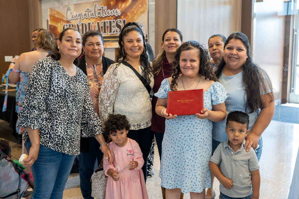LINK 18+ Graduate smiles with family.